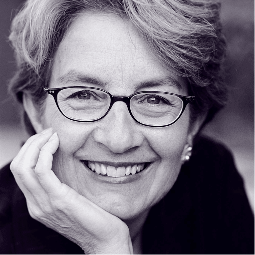 Black and white portrait of a smiling woman with glasses