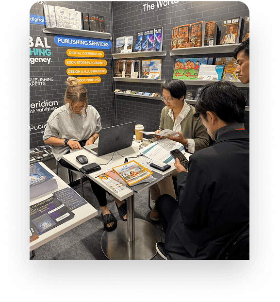 Author at a book fair booth with copies arranged on the table