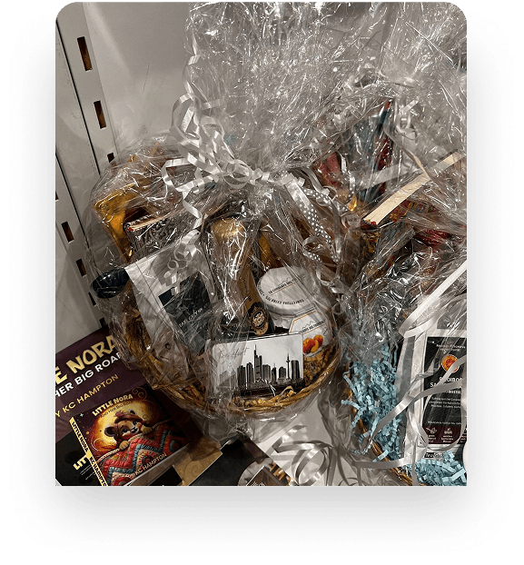 A gift basket of books wrapped for an event giveaway